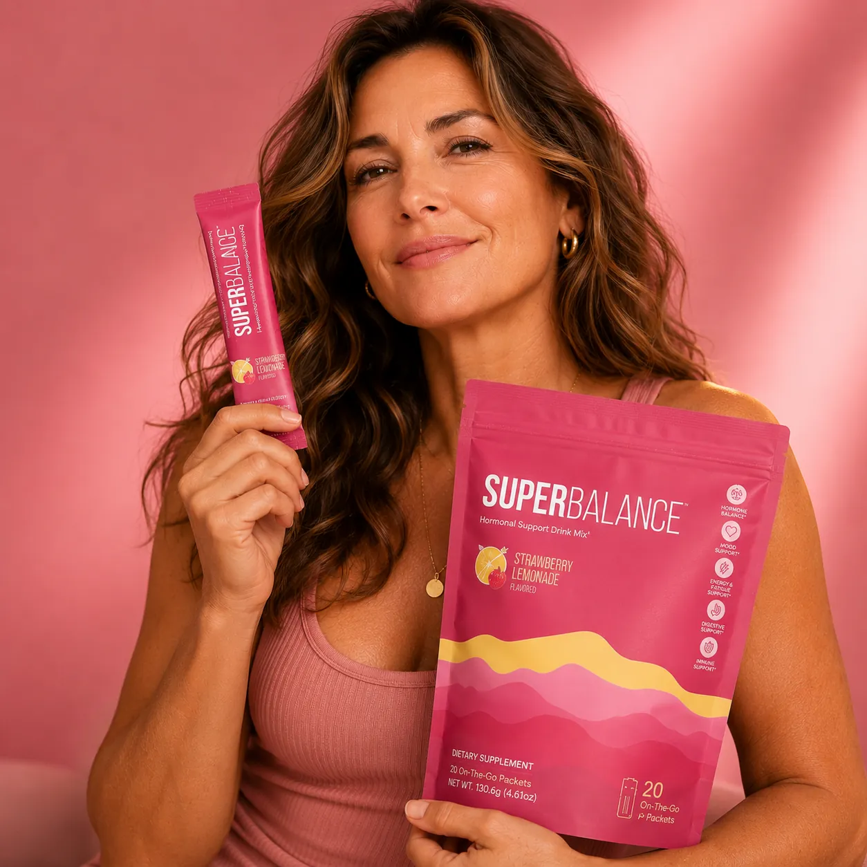 Woman holding a SuperBalance pouch and stick pack